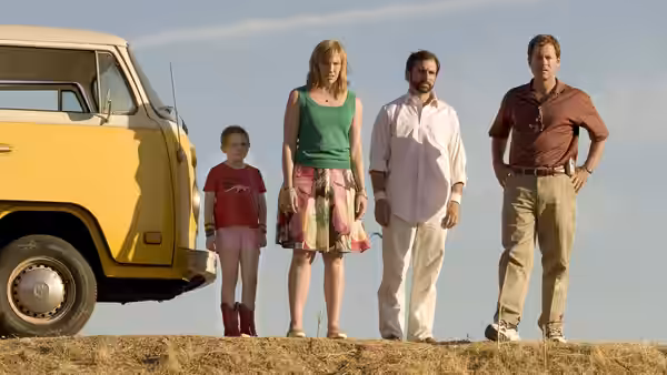 Olive Hoover, Sheryl Hoover, Frank Ginsberg and Richard Hoover standing by a yellow van