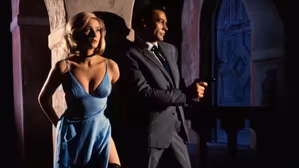James Bond (Sean Connery) holding a gun beside Tatiana Romanova (Daniela Bianchi) in an archway