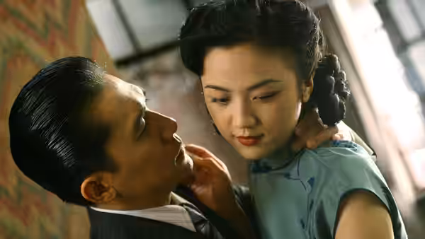 Mr. Yee (Tony Leung) holds Wong Chia Chi (Tang Wei) close as she looks away