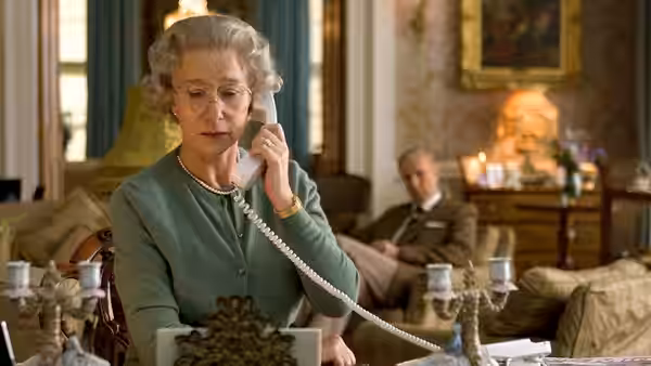Queen Elizabeth II (Helen Mirren) speaking on the telephone in a sitting room