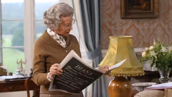 Queen Elizabeth II (Helen Mirren) reading a newspaper about Diana