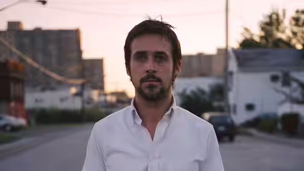 Dan Dunne (Ryan Gosling) standing on a street at dusk