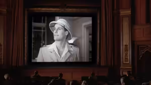 Man in a pith helmet projected on a movie theater screen