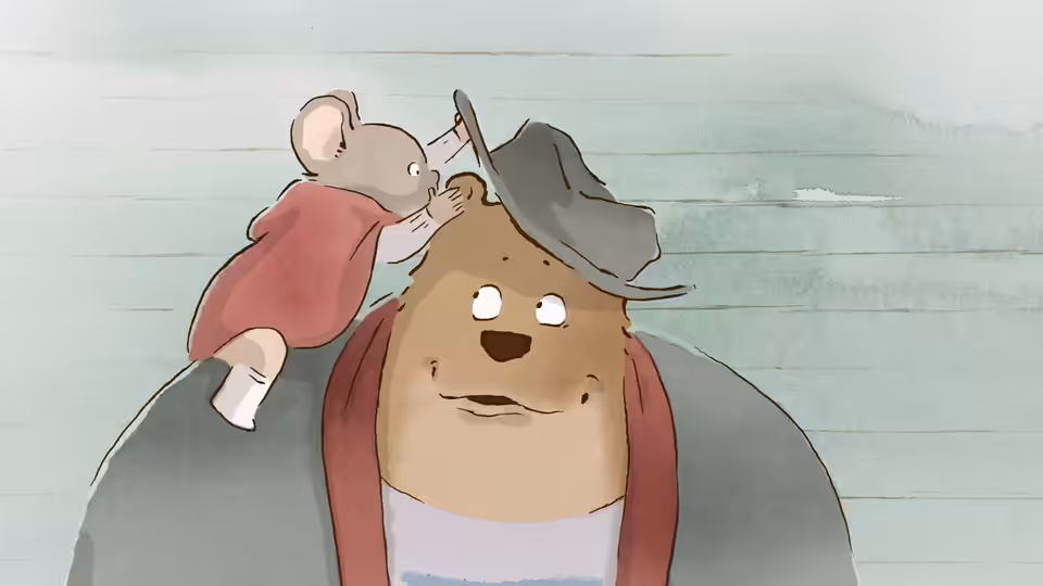 Célestine perched atop Ernest's head as he wears a gray hat