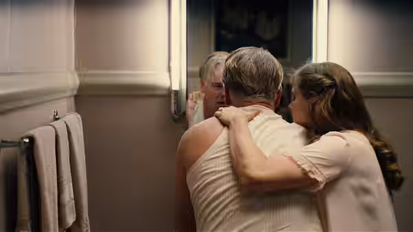 Lancaster Dodd (Philip Seymour Hoffman) and Peggy Dodd (Amy Adams) embrace before a mirror