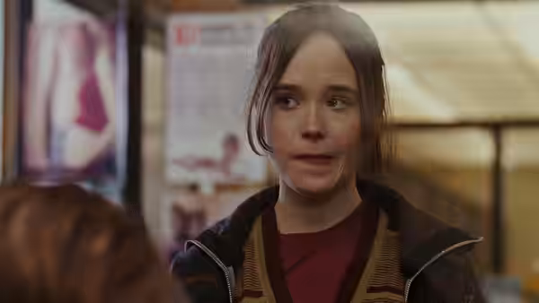 Juno (Elliot Page) looking surprised in a room with posters on the wall