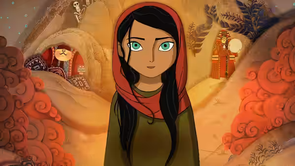 Parvana (Saara Chaudry) in a red headscarf stands in an ornate cave decorated with patterns