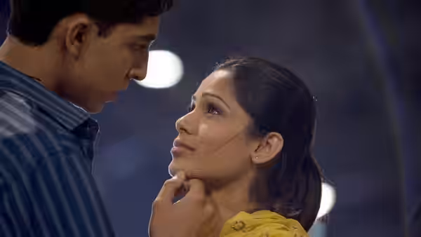 Jamal (Dev Patel) gently holds Latika's (Freida Pinto) face in close-up