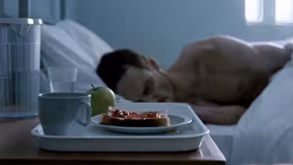 Bobby Sands (Michael Fassbender) sleeps in bed with a breakfast tray nearby