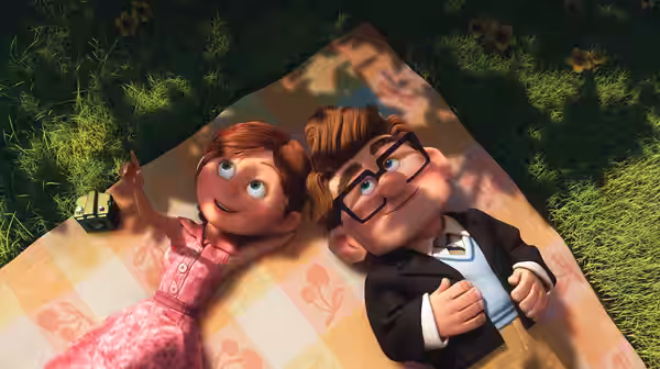 Young Carl and young Ellie lying on a picnic blanket in the grass