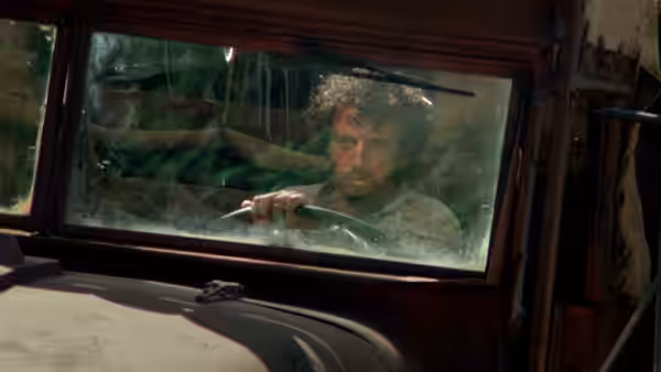 Scanlon (Roy Scheider) grips the wheel inside a truck cab