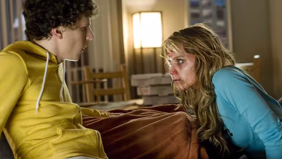 Columbus (Jesse Eisenberg) facing 406 (Amber Heard) indoors