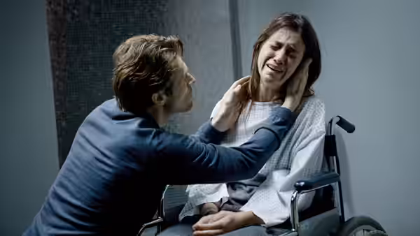 He (Willem Dafoe) comforting She (Charlotte Gainsbourg) in a wheelchair