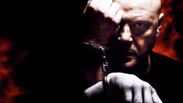 Vic Mackey (Michael Chiklis) with handcuffs and hand on his forehead