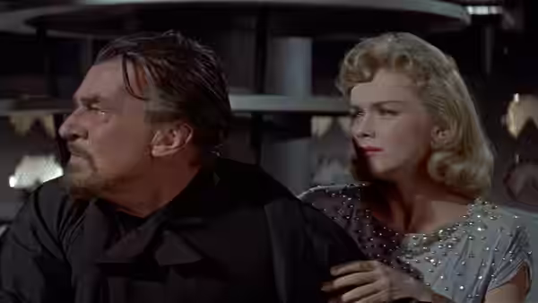 Dr. Morbius and Altaira look off-screen from inside the spacecraft