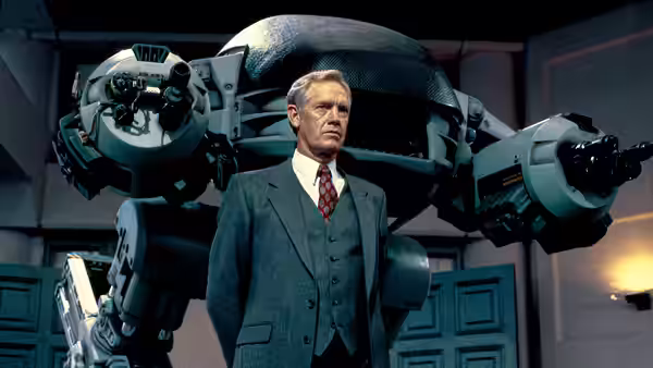 The Old Man (Dan O'Herlihy) standing before a large armed robot