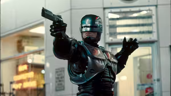 RoboCop (Peter Weller) pointing a pistol with his left arm raised