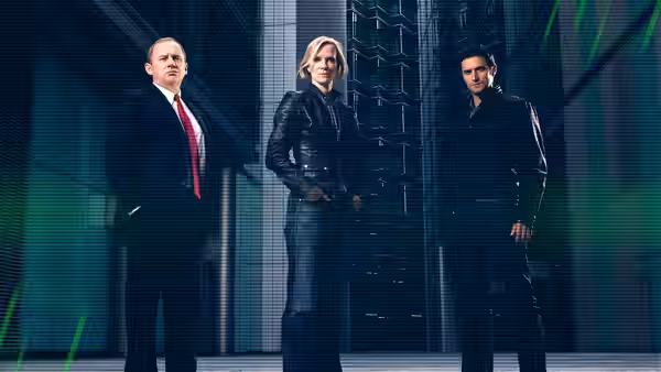 Harry Pearce (Peter Firth) with Ros Myers (Hermione Norris) and Adam Carter (Rupert Penry-Jones) in a sleek corridor