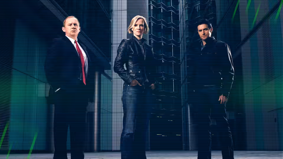 Harry Pearce (Peter Firth) with Ros Myers (Hermione Norris) and Adam Carter (Rupert Penry-Jones) in a sleek corridor
