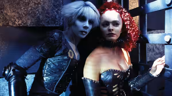 Chiana and a red-haired woman in leather outfits standing together