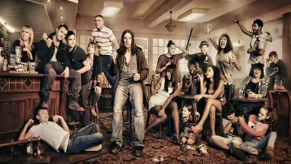 Frank Gallagher (David Threlfall) holding a bottle in a crowded pub