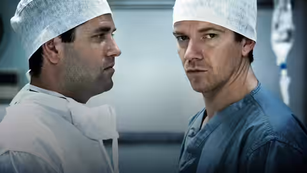Rob Lake (Max Beesley) faces colleague in surgical caps and gowns
