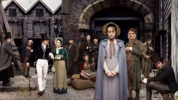 Amy Dorrit (Claire Foy) standing with clasped hands before a group in period dress