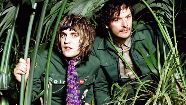 Vince Noir (Noel Fielding) and Howard Moon (Julian Barratt) hiding among green plants