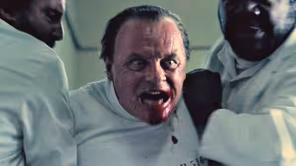 Hannibal Lecter (Anthony Hopkins) struggles as attendants restrain him in a white shirt