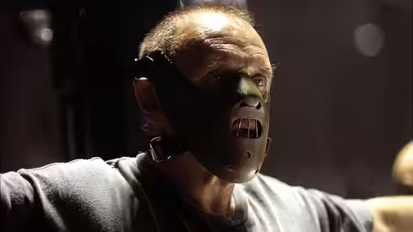 Hannibal Lecter (Anthony Hopkins) wears a muzzle in a dark room