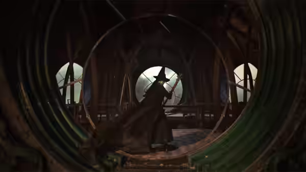 Elphaba (Cynthia Erivo) in a black cloak inside a green circular structure