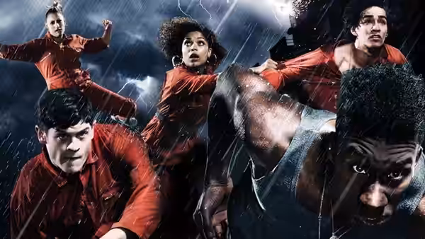 young adults in red jumpsuits striking poses in heavy rain