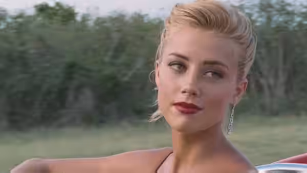 Chenault (Amber Heard) looks to the side from a car against a wooded background