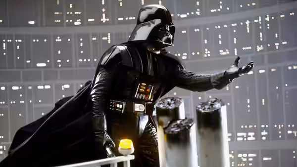Darth Vader gesturing with his hand in a large control room