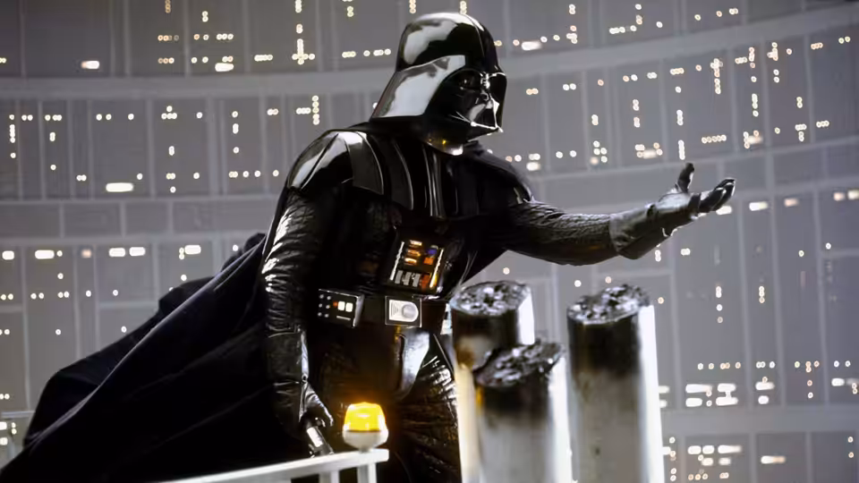 Darth Vader gesturing with his hand in a large control room