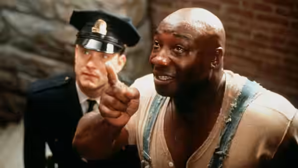 John Coffey (Michael Clarke Duncan) points ahead beside a prison guard