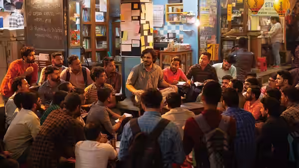 Young men gathered around a table in a busy study room