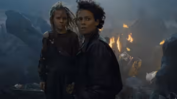 Ripley (Sigourney Weaver) and Newt (Carrie Henn) in a rocky fiery landscape