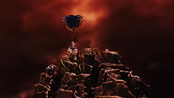 A blue flower growing from a rocky peak against a red sky
