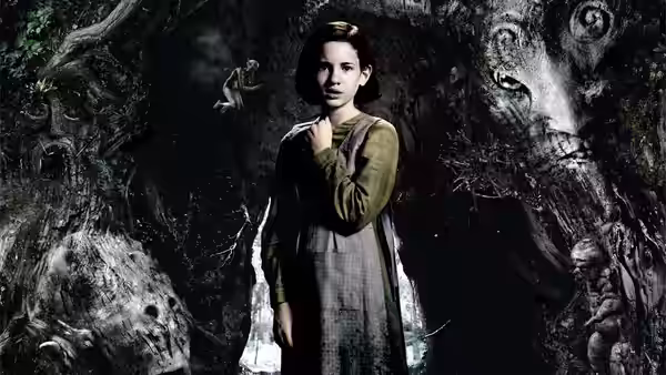 Ofelia (Ivana Baquero) standing among twisted trees in a dark forest