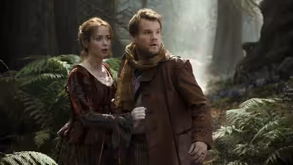 The Baker (James Corden) and his wife (Emily Blunt) peer alertly into the forest
