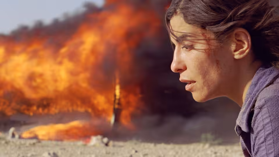 Nawal (Lubna Azabal) watches a massive fire rage across the desert