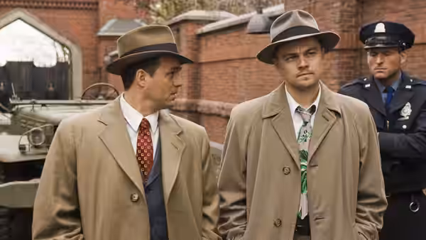 Teddy Daniels (Leonardo DiCaprio) and Chuck Aule (Mark Ruffalo) confer near a policeman
