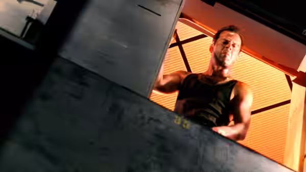 John McClane (Bruce Willis) looking down from an open shaft