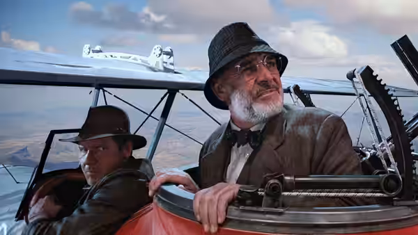 Indiana Jones (Harrison Ford) and Henry Jones (Sean Connery) in the cockpit of a biplane