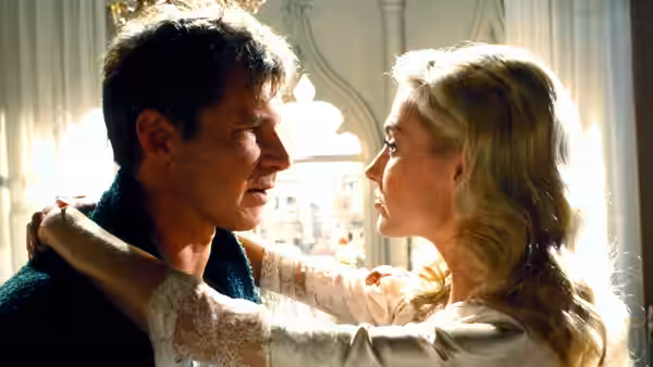 Indiana Jones (Harrison Ford) and Elsa (Alison Doody) facing each other in close embrace