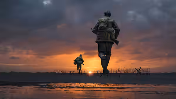 Two soldiers run across a muddy field at sunset
