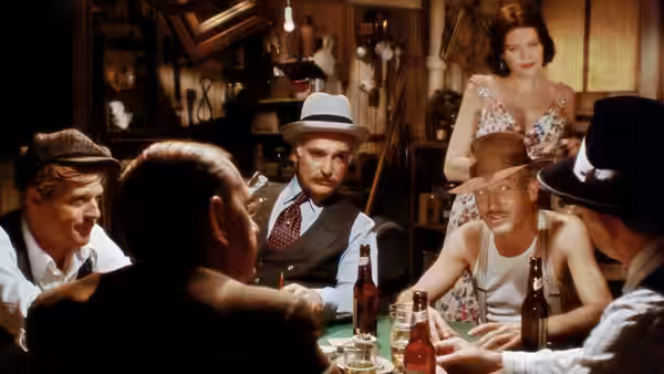 Group of men gamble at table while woman stands nearby