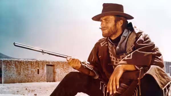 Manco (Clint Eastwood) seated with a rifle across his lap
