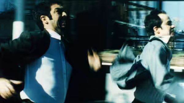 Marcos (Ricardo Darín) and Juan (Gastón Pauls) run through a crowded interior